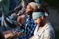 Portrait of a young handsome hispanic latino and an African American male trumpet player sitting next to each other