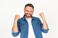 Portrait of young handsome man with beard wearing casual clothes on white background very happy and excited doing winner gesture Royalty Free Stock Photo