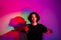 Portrait of young handsome man with colorful shadows on photographic background