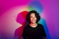 Portrait of young handsome man with colorful shadows on photographic background