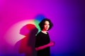 Portrait of young handsome man with colorful shadows on photographic background