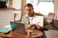 Portrait of young handsome man in glasses, private tutor teaching student online, pointing at his notebook, showing Royalty Free Stock Photo