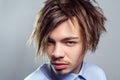 Man with mustache and beard with fringe messy hairstyle, looking at camera with serious expression. Royalty Free Stock Photo