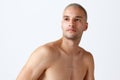 Portrait of young handsome man posing shirtless against white studio background. Male model with well-kept healthy skin Royalty Free Stock Photo