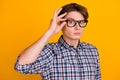 Portrait of young handsome man in shirt isolated on vibrant background touching his glasses Royalty Free Stock Photo