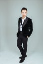 Young handsome man in a suit, standing and looking at the camera Royalty Free Stock Photo