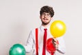 Portrait of a young man with balloons in a studio. Royalty Free Stock Photo