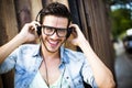 Young man listening music on the street - hipster style