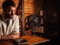 Portrait of young handsome man in white suit near home bar. Royalty Free Stock Photo