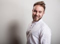 Portrait of young handsome positive man in white shirt with an amusing pattern