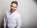 Portrait of young handsome positive man in white shirt with an amusing pattern