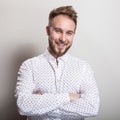 Portrait of young handsome positive man in white shirt with an amusing pattern