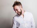 Portrait of young handsome positive man in white shirt with an amusing pattern