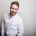 Portrait of young handsome positive man in white shirt with an amusing pattern