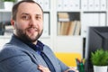 Portrait of young handsome promising businessman in office