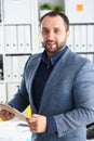 Portrait of young handsome promising businessman in office