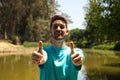 Portrait young handsome red-haired man, happy, smiling, showing his thumbs up with his hands. Positive human emotion, facial