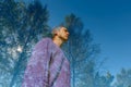 Double exposure of young handsome man and tall green trees overlaying against blue sky Royalty Free Stock Photo