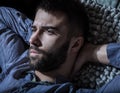 Portrait of young handsome serious man in a hammock.