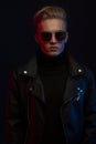 Portrait of young handsome man in leather jacket and sungl Royalty Free Stock Photo