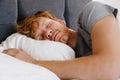Portrait of young handsome sleeping redhead man in gray t-shirt Royalty Free Stock Photo