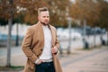 Portrait of young handsome stylish man in elegant coat Royalty Free Stock Photo