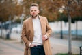 Portrait of young handsome stylish man in elegant coat Royalty Free Stock Photo