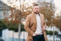 Portrait of young handsome stylish man in elegant coat Royalty Free Stock Photo