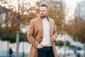 Portrait of young handsome stylish man in elegant coat Royalty Free Stock Photo