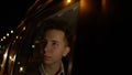 Portrait of young handsome teenager traveling in a taxi car with a driver in night city Royalty Free Stock Photo