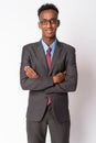 Portrait of young happy African businessman with eyeglasses crossing arms Royalty Free Stock Photo