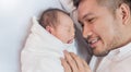 Portrait of young happy asian father with his newborn baby, copy space with bed in the hospital background. Royalty Free Stock Photo