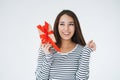 Portrait of young happy asian woman with gift box in hands on white background isolated Royalty Free Stock Photo