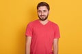 Portrait of young happy attractive bearded guy, handsome male wearing red casual t shirt, smiling and looking directly at camera Royalty Free Stock Photo