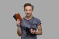 Portrait of young happy boy holding passports and binoculars.