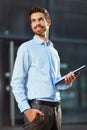 Portrait of a young happy businessman outside the office building Royalty Free Stock Photo