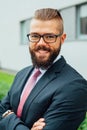 Portrait of a young happy businessman outside the office buildin Royalty Free Stock Photo