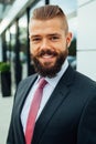 Portrait of a young happy businessman outside the office buildin Royalty Free Stock Photo