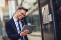 Young happy businessman outside the office building, enters the building Royalty Free Stock Photo