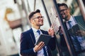 Young happy businessman outside the office building, enters the building Royalty Free Stock Photo