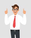 Portrait of young happy businessman pointing hand index fingers up, concept of advertisement product,introduce something.