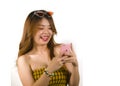 Young happy and cheerful Asian Korean girl with fashion sunglasses and top holding mobile phone online dating or flirting at Royalty Free Stock Photo