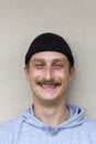 Portrait of young happy and cheerful man isolated on gray background