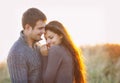 Portrait of young happy couple laughing in a cold day by the autumn sea Royalty Free Stock Photo