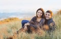 Portrait of young happy couple laughing in a cold day by the sea Royalty Free Stock Photo