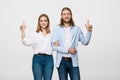 Portrait young happy couple love smiling embracing point finger to empty copy space, man and woman smile looking up Royalty Free Stock Photo