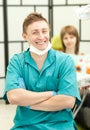 Portrait of young happy dentist in his surgery