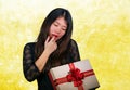 portrait of young happy and excited beautiful Asian Chinese woman receiving a romantic anniversary gift box holding the Royalty Free Stock Photo