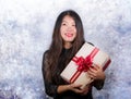 portrait of young happy and excited beautiful Asian Japanese woman receiving a romantic anniversary gift box holding the Royalty Free Stock Photo