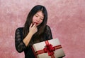 portrait of young happy and excited beautiful Asian Korean woman receiving a romantic anniversary gift box holding the r Royalty Free Stock Photo